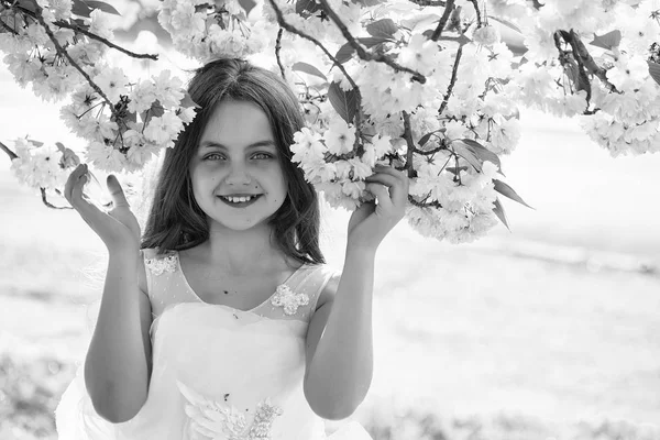 Small smiling girl in blossom — Stock Photo, Image