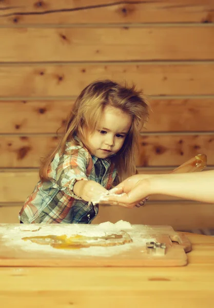Mãos femininas ajudam a criança a cozinhar com massa, farinha, ovo — Fotografia de Stock