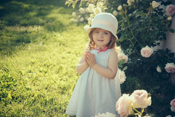 Dívka Klobouku Modlí Ruce Letní Zahradě Dítě Stojící Kvetoucí Růže — Stock fotografie
