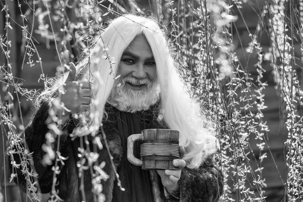 Бородатий чоловік з чашкою в цвітіння — стокове фото