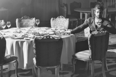 Sakal ve sarışın saçlı yakışıklı genç adam artık yemek veya artıkları ile masada oturan cam Şarap içer Ziyafet yemekten sonra kirli tabak restoranda yemek