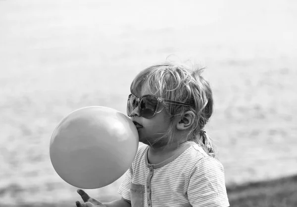 Lindo bebé niño juega con amarillo juguete globo — Foto de Stock