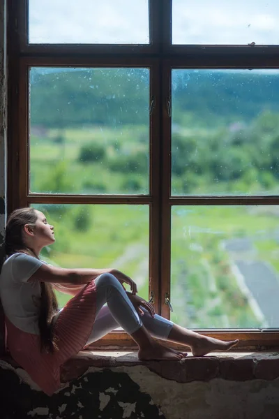 Small child sleep on window sill with summer landscape view — Stock Photo, Image