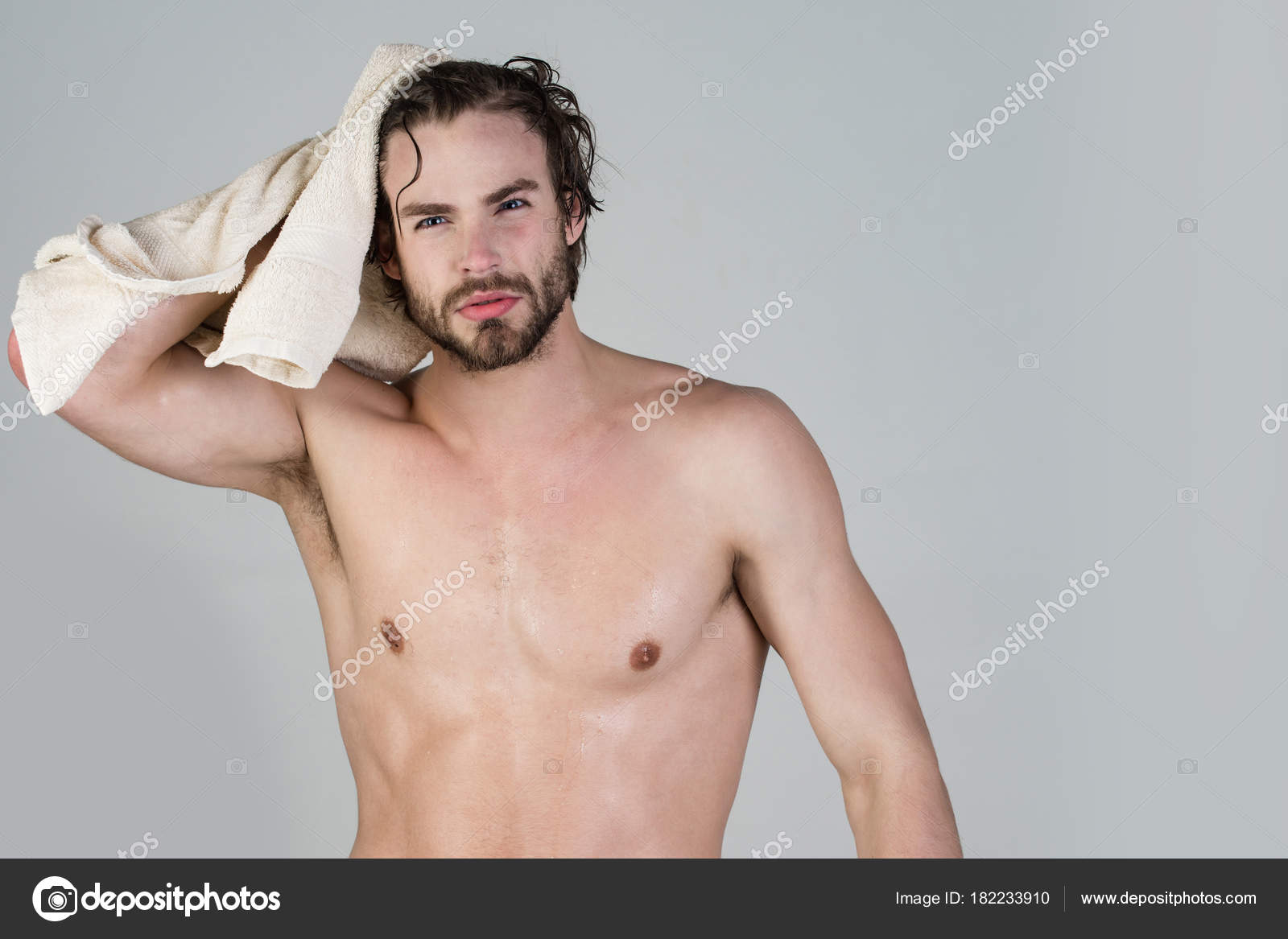 Man with wet hair hold towel after shower. Stock Photo by ©  182233910
