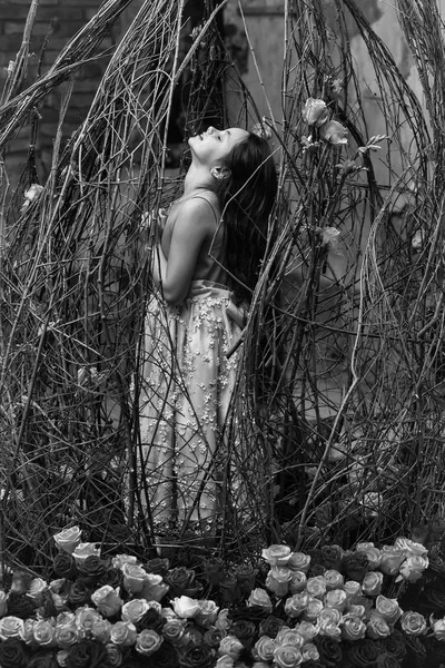 Small girl near mirror and pink flowers