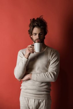 sleepy man with disheveled hair drink coffee in morning, cold clipart