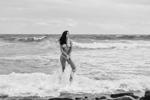 Pretty girl in sexi yellow swimsuit standing on rock — Stock Photo, Image