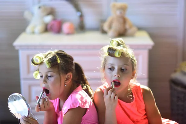 Kleine meisjes doen make-up zit in kamer met speelgoed — Stockfoto