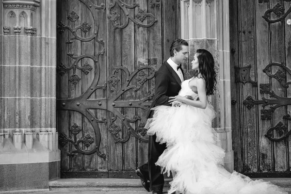 Casamento casal sexy perto de porta de ferro de madeira — Fotografia de Stock