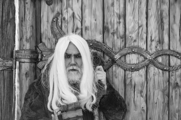 bearded man with wooden mug