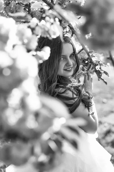 Small smiling girl in blossom — Stock Photo, Image