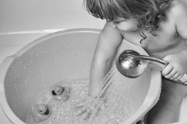 Baby boy in bath with duckling — Stock Photo, Image