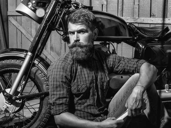 bearded biker man with wrench