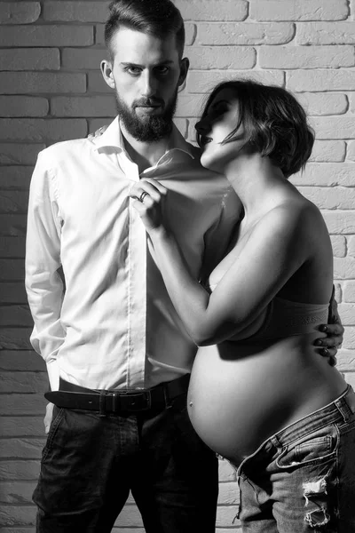 Bearded man and pretty pregnant woman with naked round belly — Stock Photo, Image