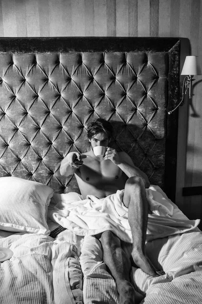 Homem barbudo na cama com café — Fotografia de Stock
