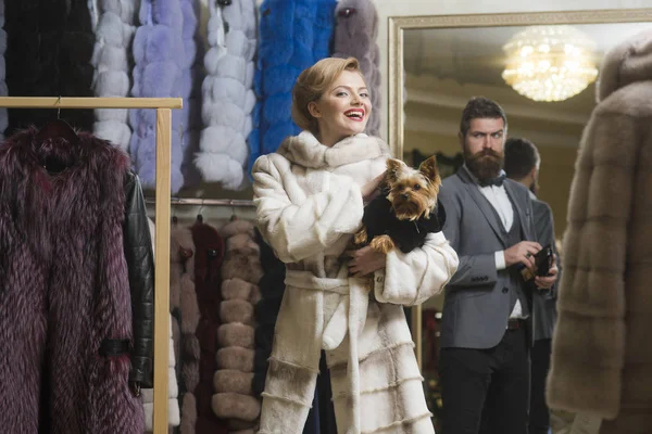 sensual woman in fur coat with man, shopping, seller, customer.