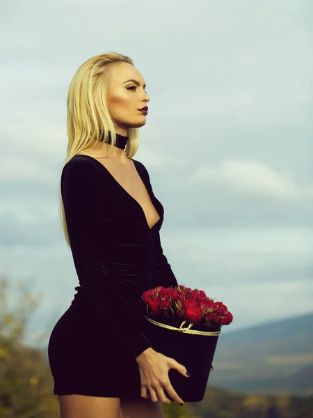 Menina bonita com flores na caixa — Fotografia de Stock