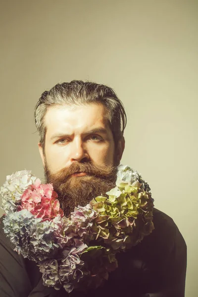 bearded man with hydrangea flowers