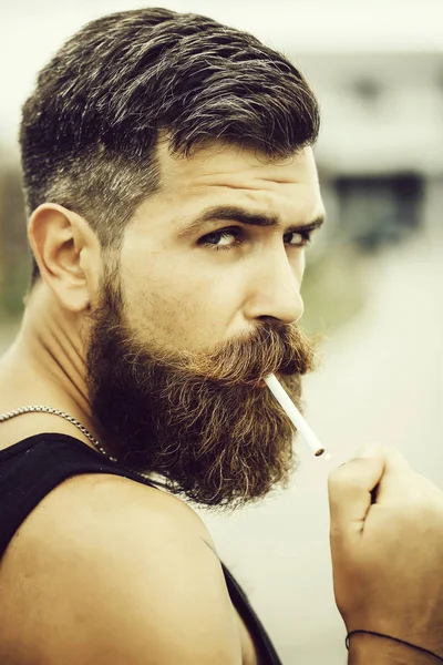 Homem de barba franzido fumando cigarro — Fotografia de Stock