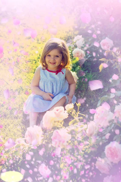 Child in spring flowers. spring flowers background. — Stock Photo, Image