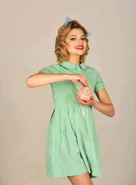 Happy young woman holding piggy bank — Stock Photo, Image