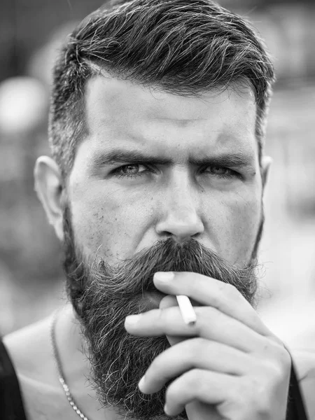 Frown bearded man smoking cigarette — Stock Photo, Image