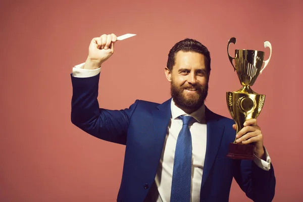 Happy businessman, man with golden champion cup and credit card — Stock Photo, Image
