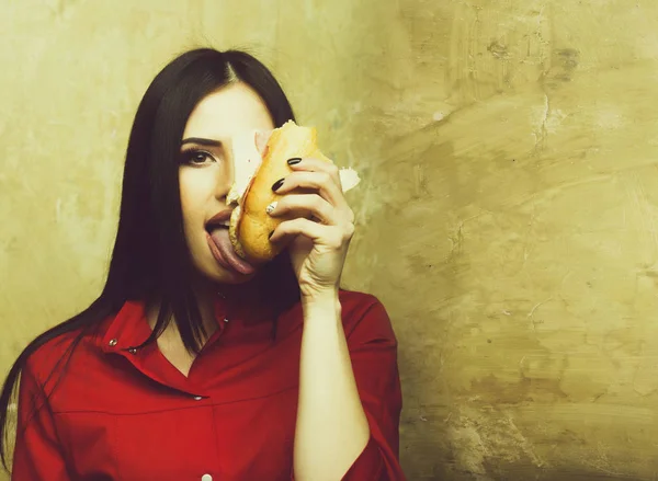 Hambrienta sexy bonita morena mujer come sándwich grande o hamburguesa — Foto de Stock