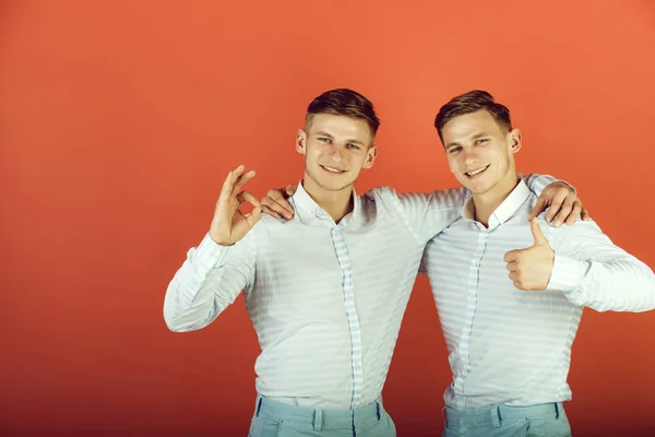 Two brothers showing thumbs up and ok gestures — Stock Photo, Image