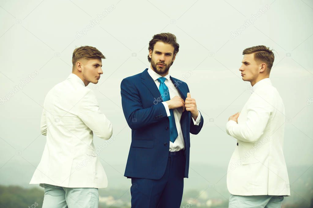 Men posing on blue sky