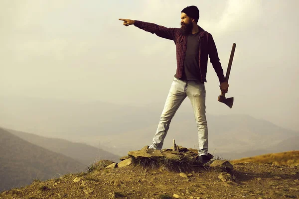 Hombre barbudo con hacha en la montaña — Foto de Stock