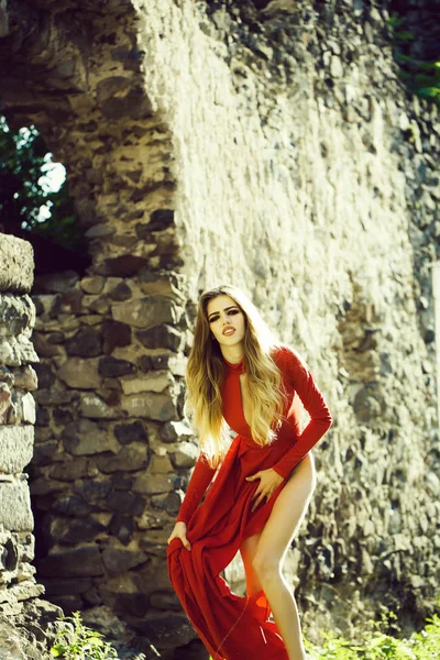 Sexy woman in red dress in ruins — Stock Photo, Image