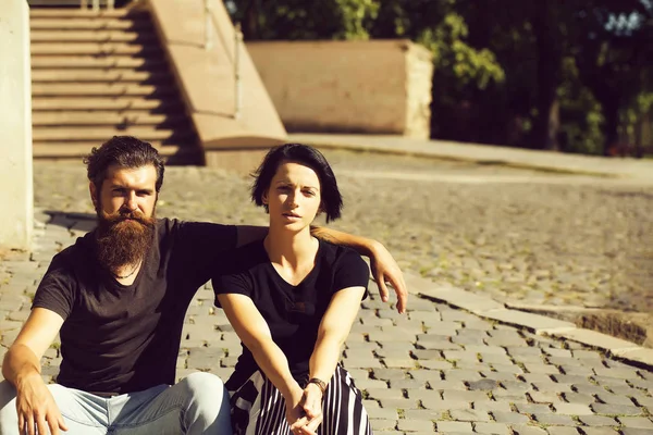 Beautiful couple sit on stairs