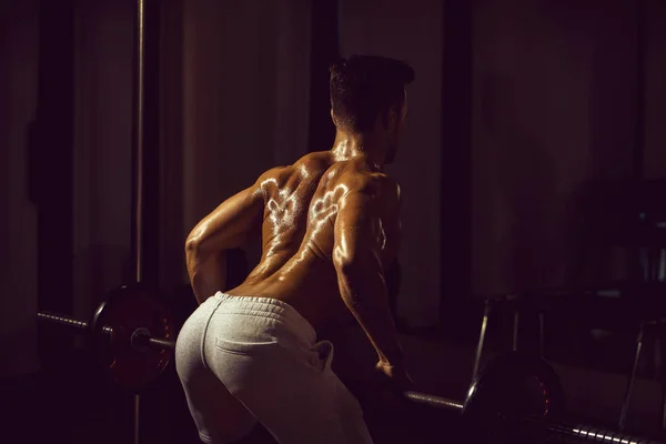 Muskuløs mand træning i gymnastik - Stock-foto