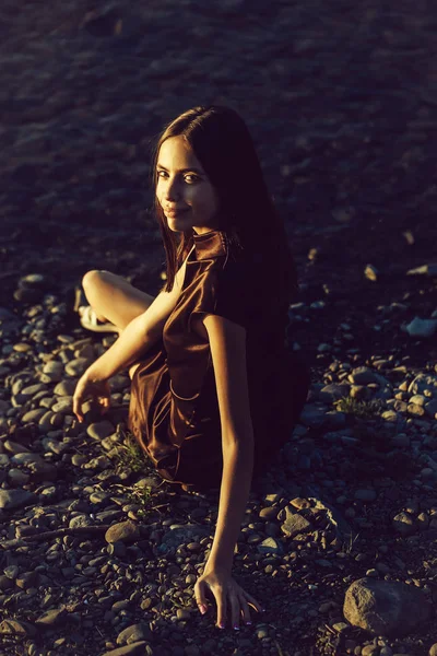 Jolie fille sur des cailloux près de l'eau — Photo