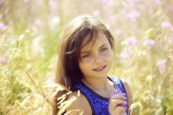 Pretty girl among flowers — Stock Photo, Image