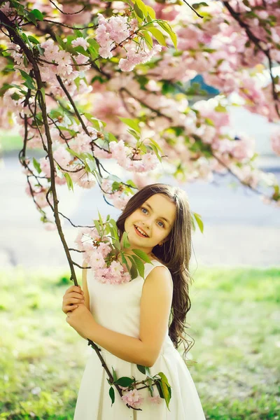 Small pretty girl in blossom — Stock Photo, Image