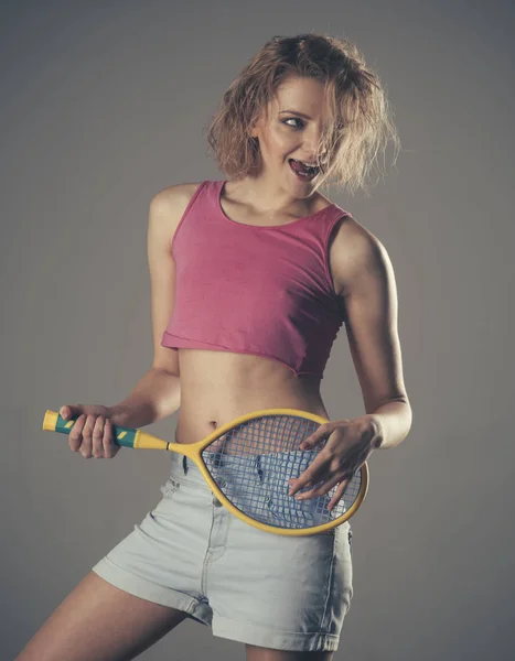 Girl with untidy hair play with tennis racquet like guitar Royalty Free Stock Photos