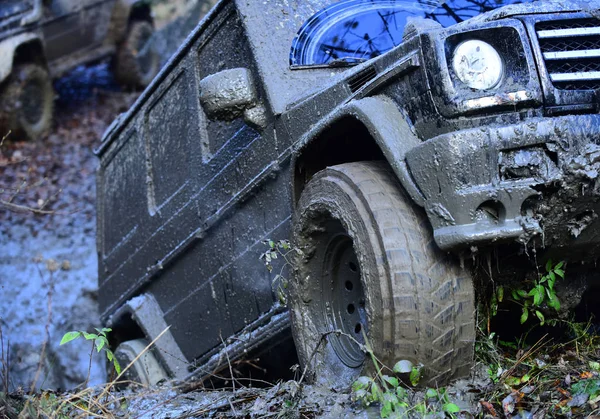 Wheel of dirty offroad car covered with mud — Stock Photo, Image