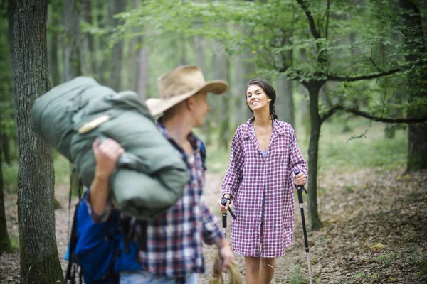 Man with woman hiking with overnight stay or picnic.