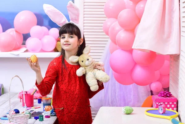 Easter, child in pink bunny ears.