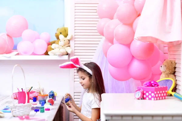 Easter, child in pink bunny ears.