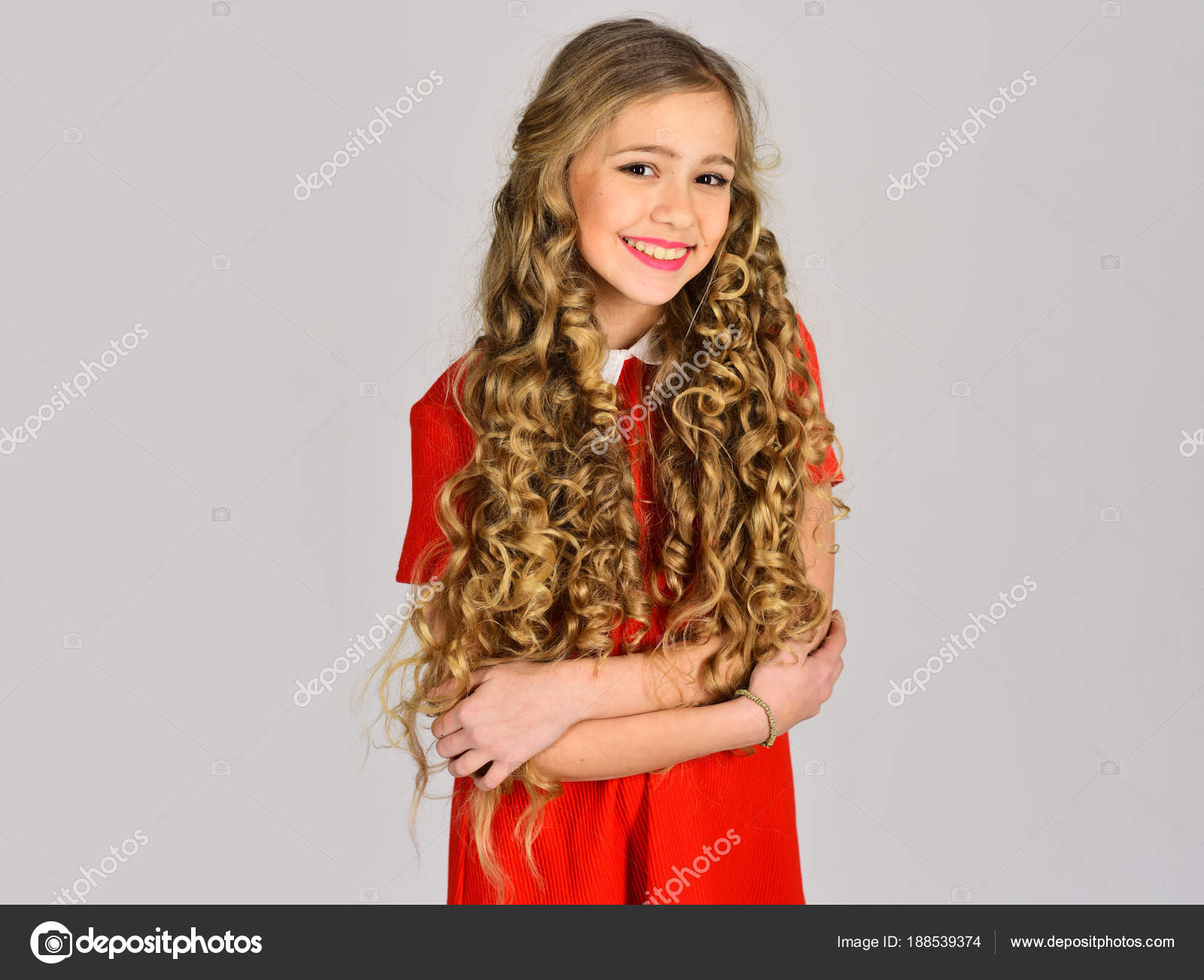 Happy Girl In Red Dress On Grey Background Hairdresser Makeup
