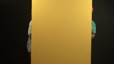Ev baştan yaratma ve yenileme: onların yeni ev Boyama genç mutlu çift. Genç mutlu komik ve onların yeni ev Boyama çift gülümsüyor. Genç çift evde tamir yapıyor ve bir duvar boyama .