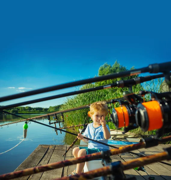 Pintoresca escena de lindo niño pescando desde el muelle de madera —  Fotos de Stock