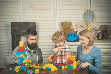 Baba, anne ve oğul açık tahta arka planda oyun odasında..
