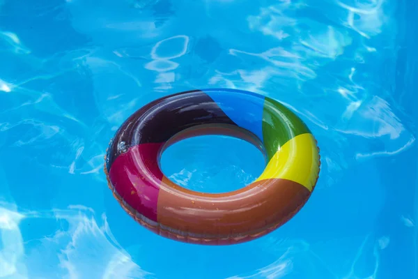 inflatable ring float in pool blue water. Summer vacation and travel to ocean, Bahamas. Maldives or Miami beach. Relax in spa luxury swimming pool. colorful swim ring or lifebuoy