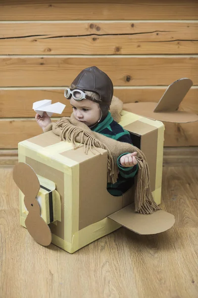 Little Boy Playing Cardboard Airplane Wooden Wall Background — Stock Photo, Image