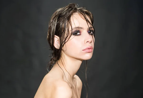 Parrucchiere e studio di visage. parrucchiere donna con capelli bagnati e occhi fumosi trucco su sfondo grigio studio — Foto Stock