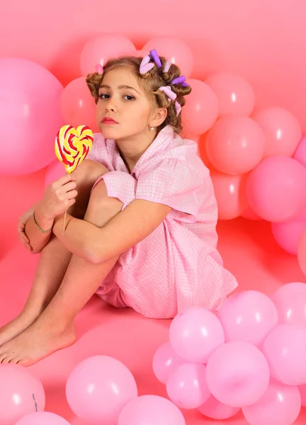 Child eat lollipop on pink. — Stock Photo, Image